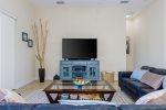 Main Living Room Features Comfortable Furnishings and a Flat Screen TV